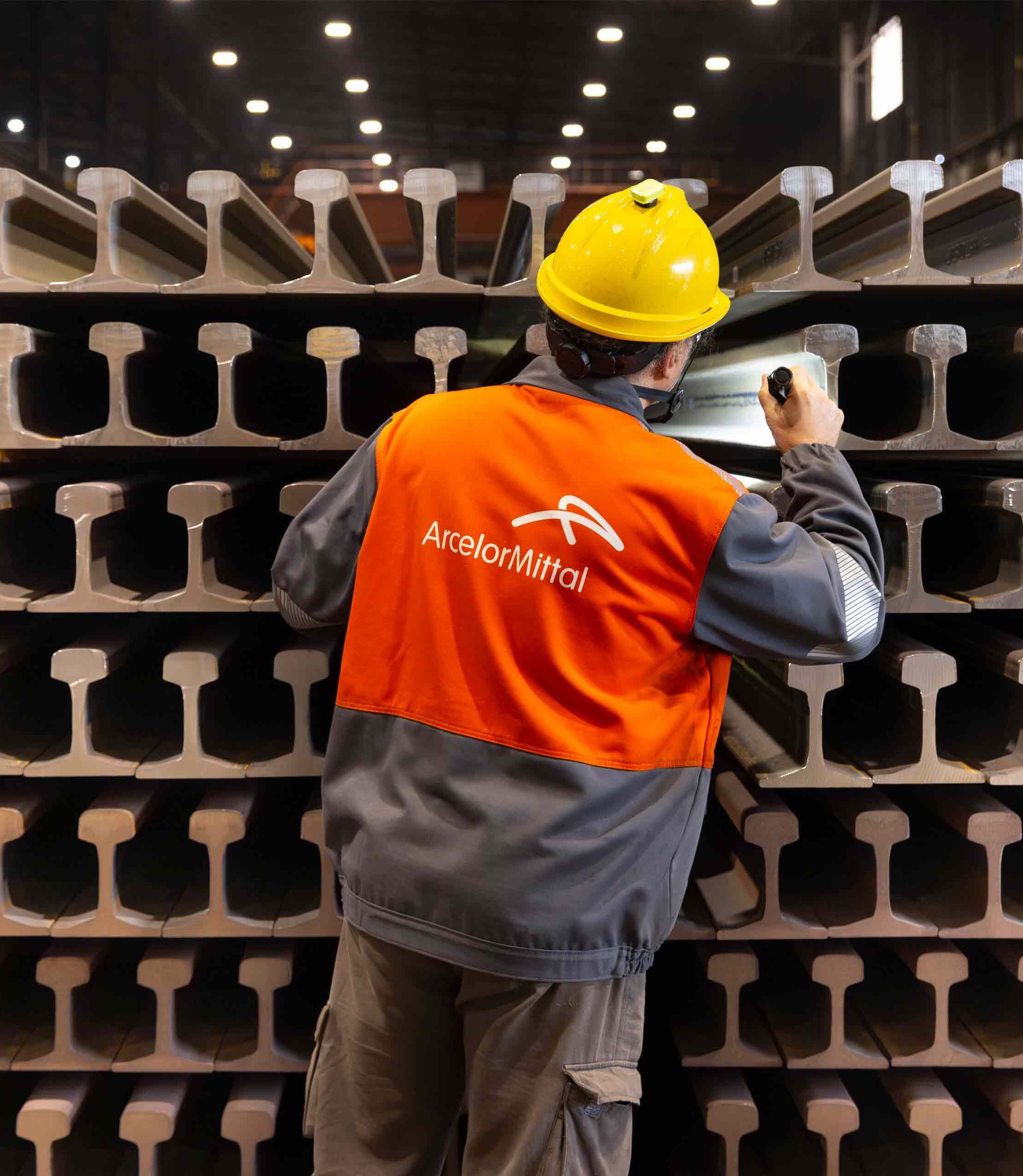 ArcelorMittal Gijon colleague inspecting completed railway rails.jpg