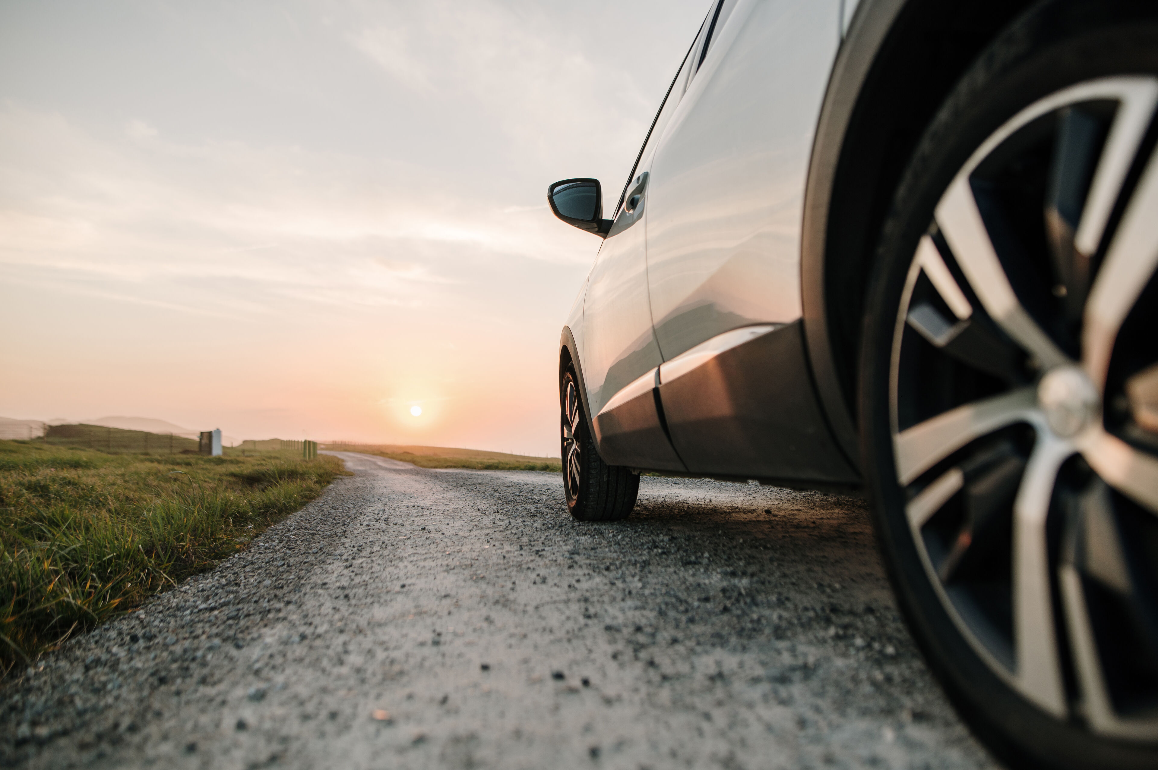 Side view of car on street in open fields