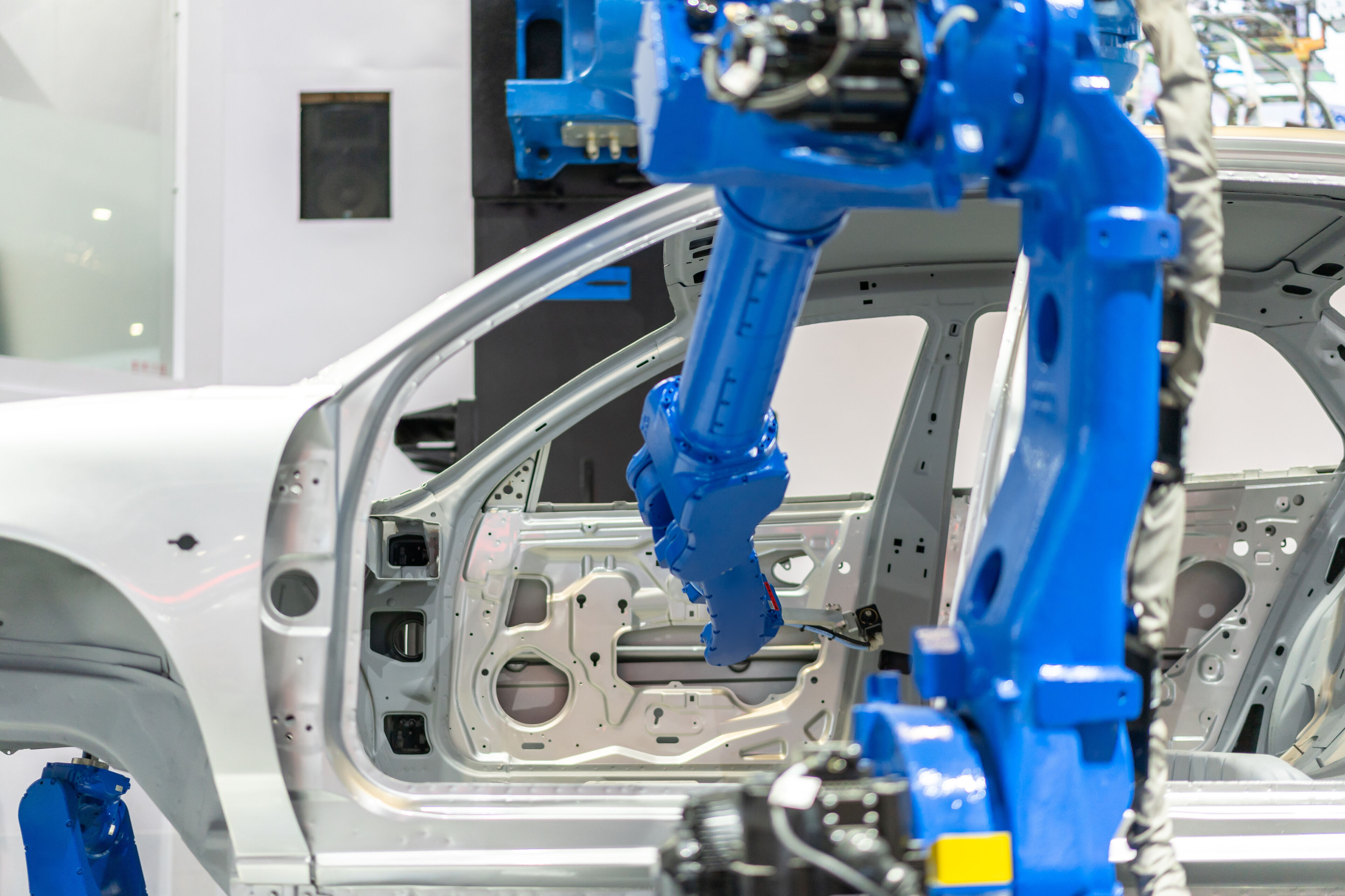 Robotic arm assembling a vehicle body