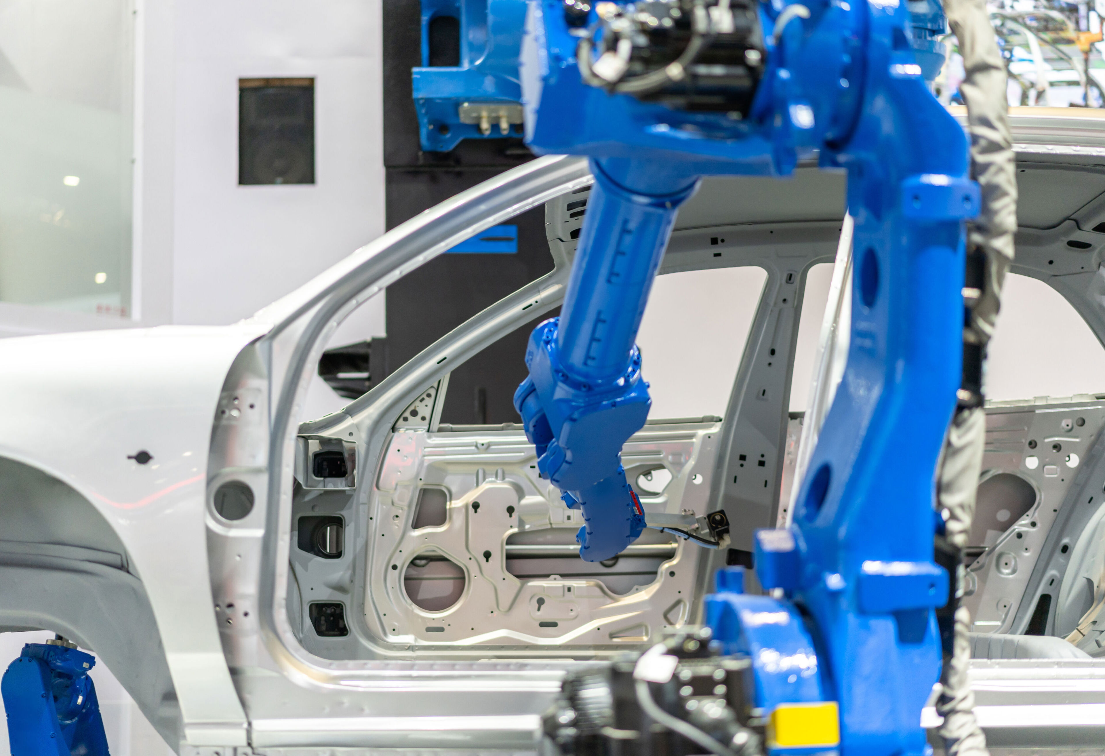 Robotic arm assembling a vehicle body