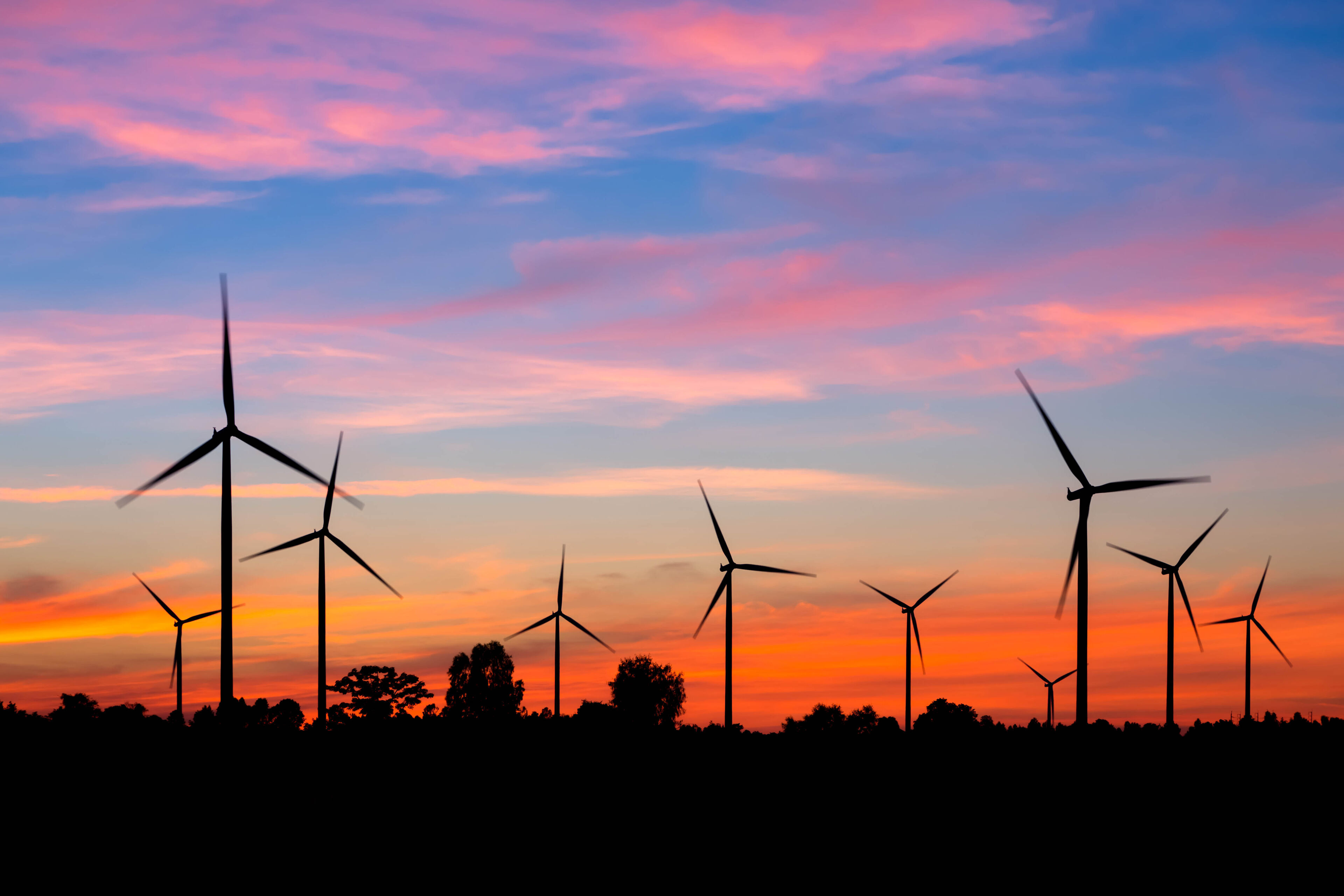 Sunset over field of wind turbines