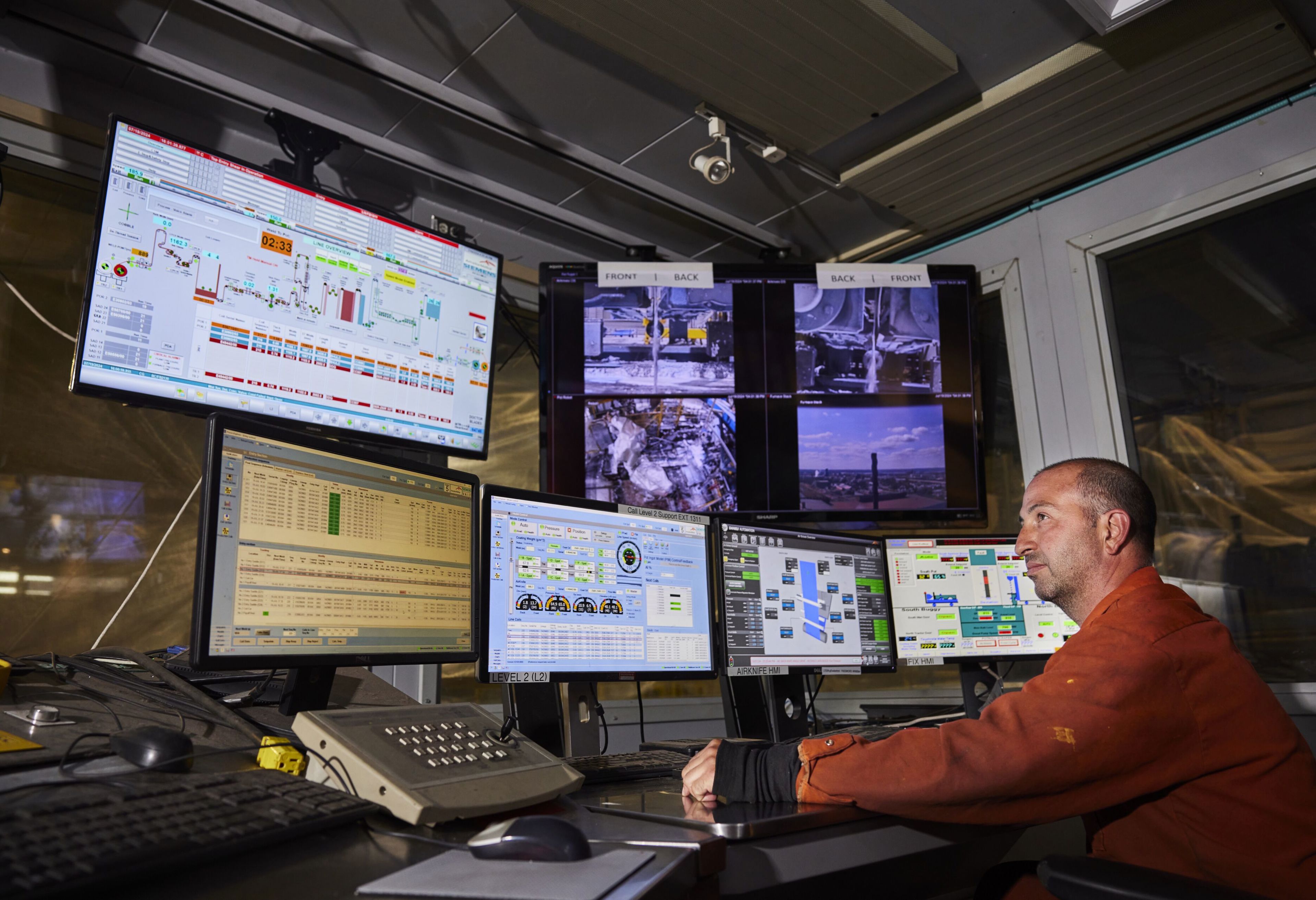 Dofasco employee looks at several monitors
