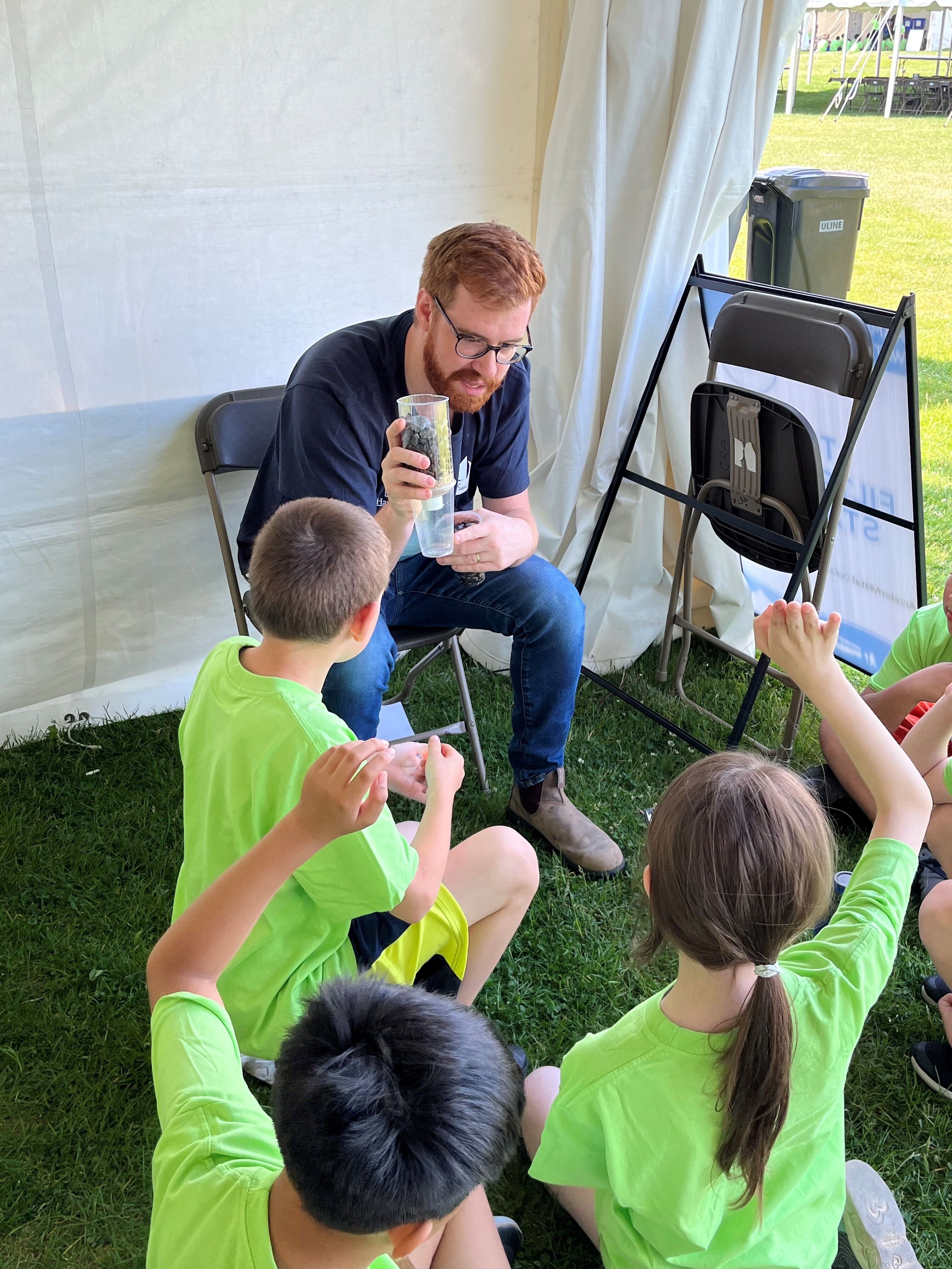 Employee meets with students for children's water festival