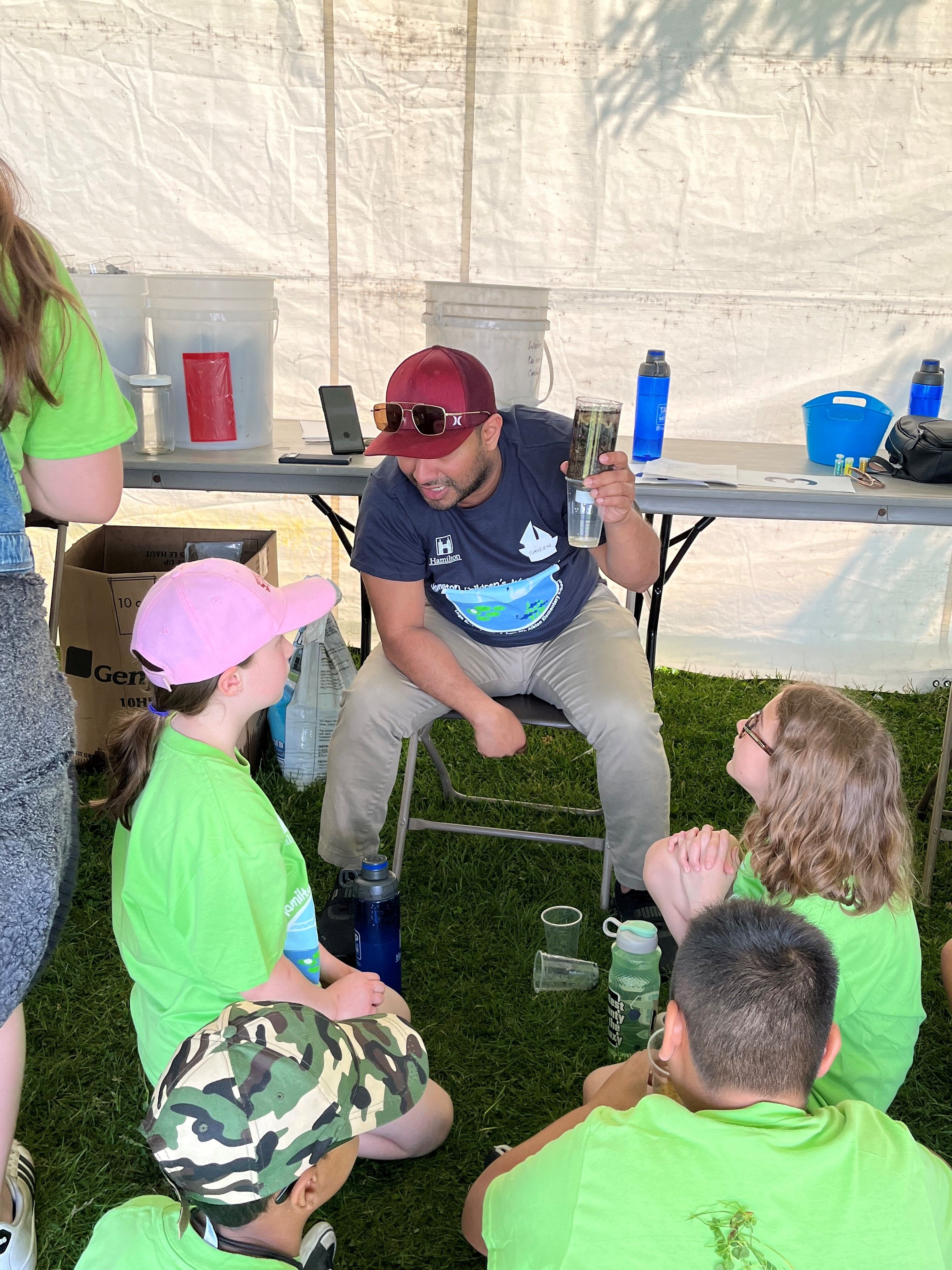 Students with employee at children's water festival