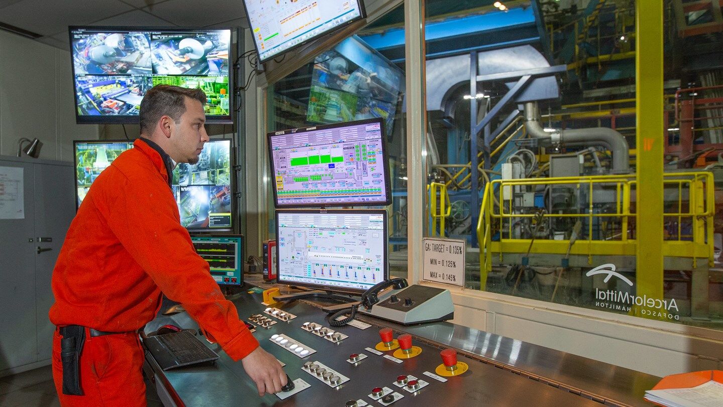 Dofasco employee looking at monitor screens