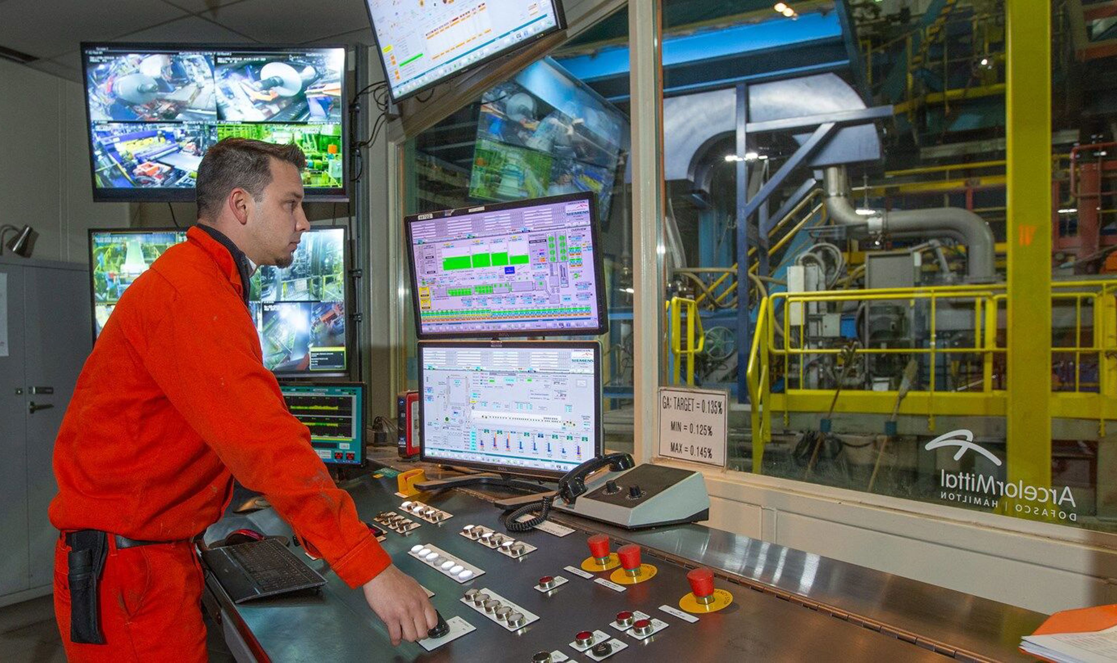Dofasco employee looking at monitor screens