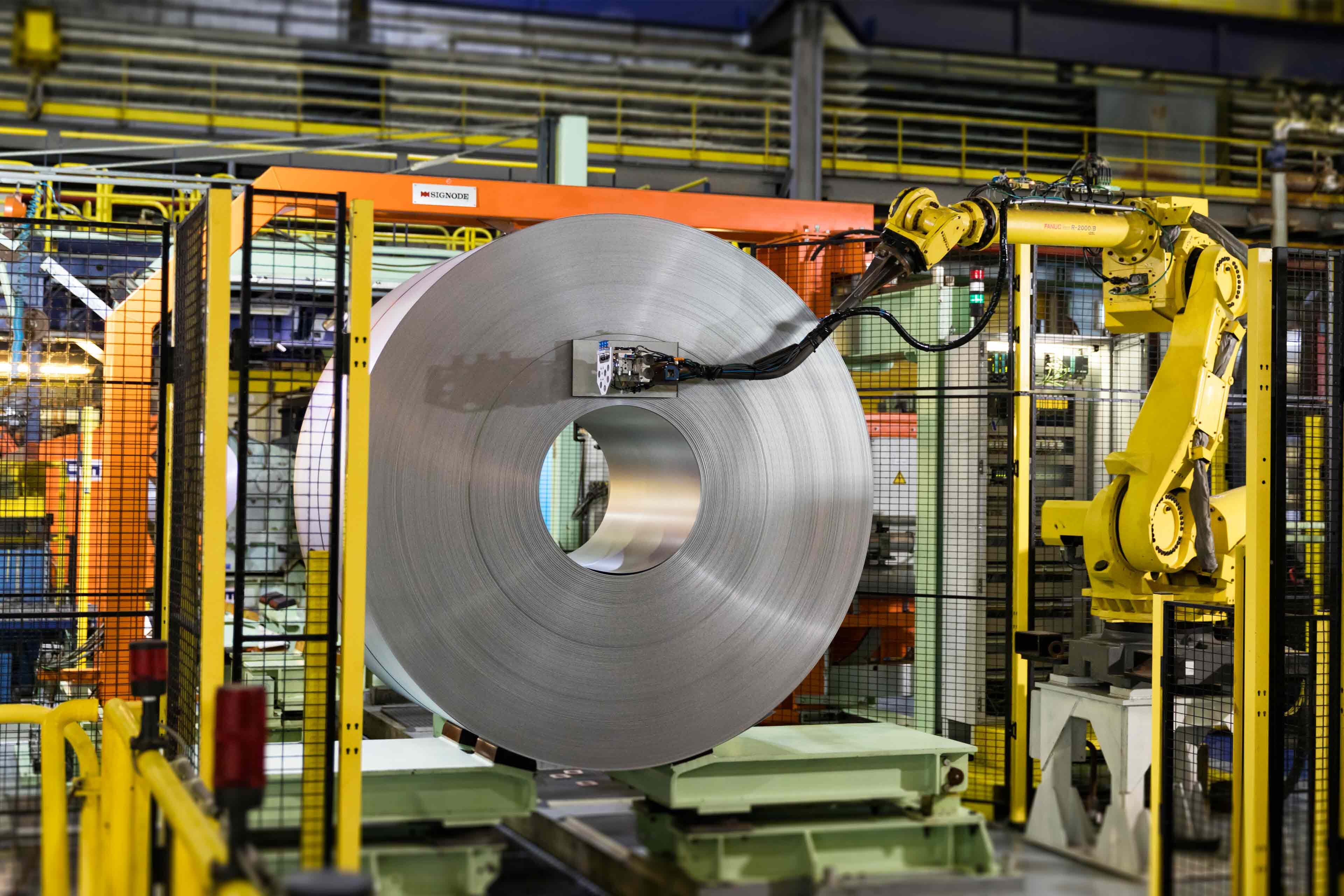 Robot preparing finished coil for packaging, Liège, Belgium.jpg